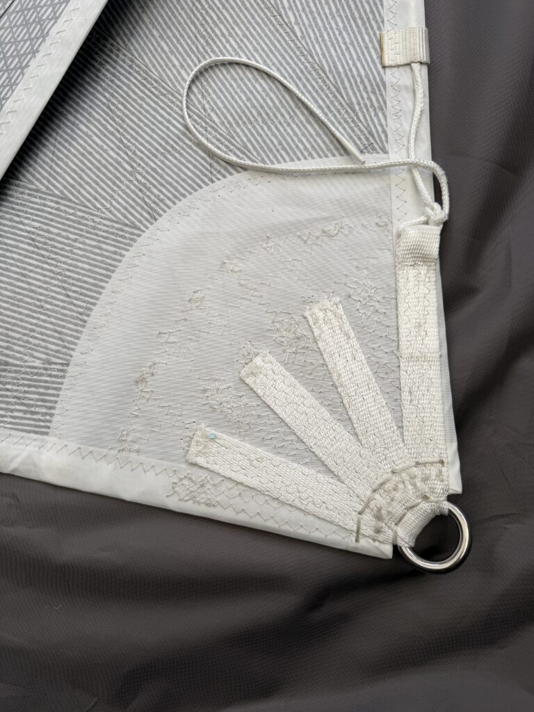 This photo shows Clew highlighting the handstitching on the SR ring with splayed webbing. You can also see the overhead leech line termination.
