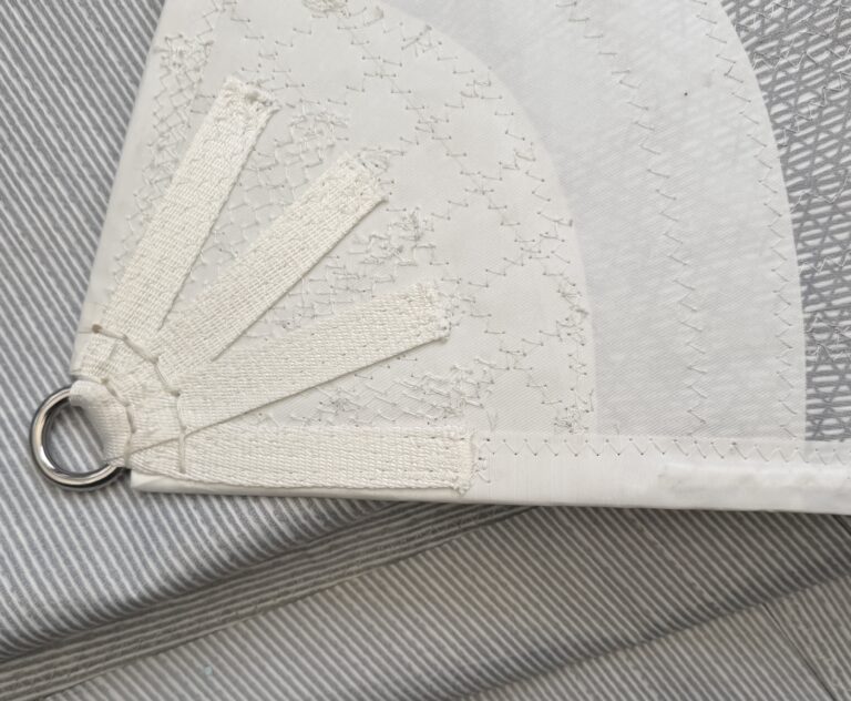 Clew hand stitching detail with quilting on radial panels and dyneema webbing splay detail.