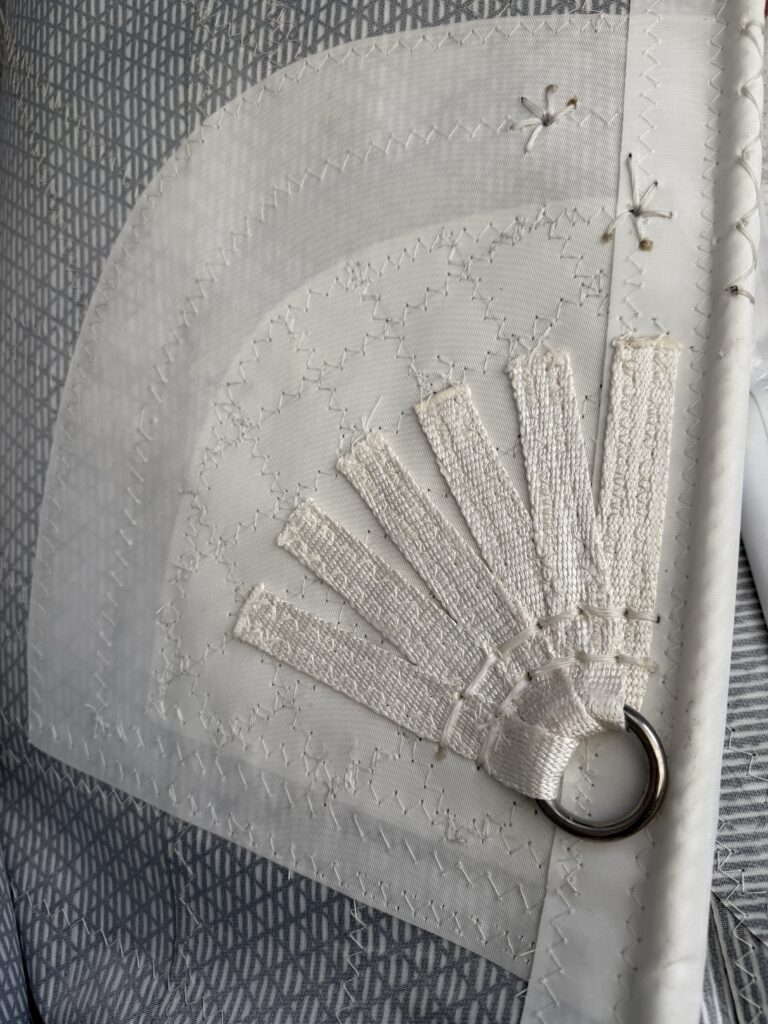 Hand Stitching detail with quilting on radial panels and dyneema webbing splay detail on luff reef point.