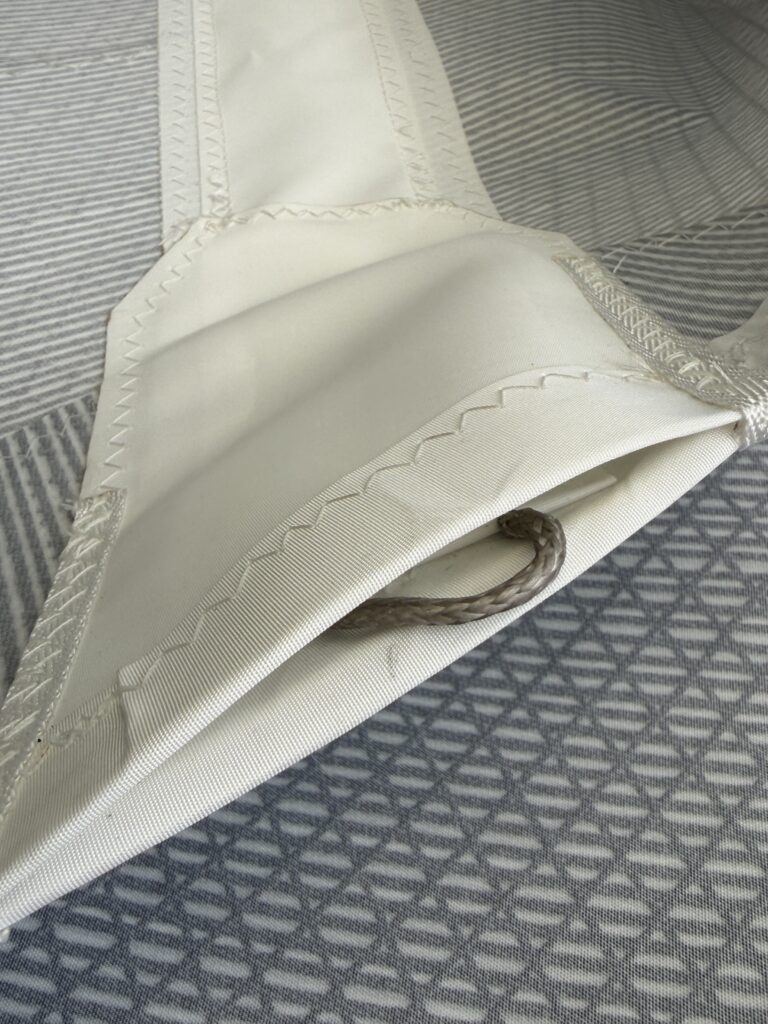 Batten pocket detail, light coastal with rocket tensioners and dyneema fittings.